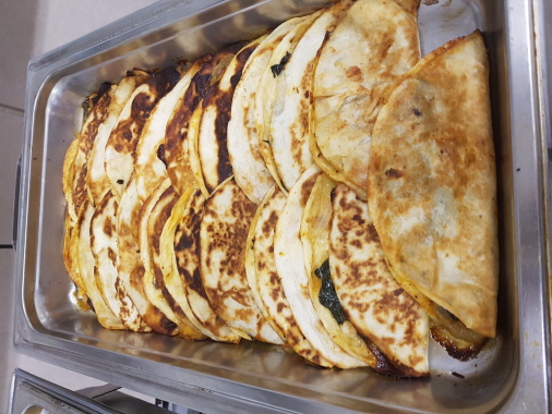 vegetable quesadillas with jalapeno jack cheese, cheddar, mozzarella, roasted tomatoes, spinach, sauteed onions and mushrooms