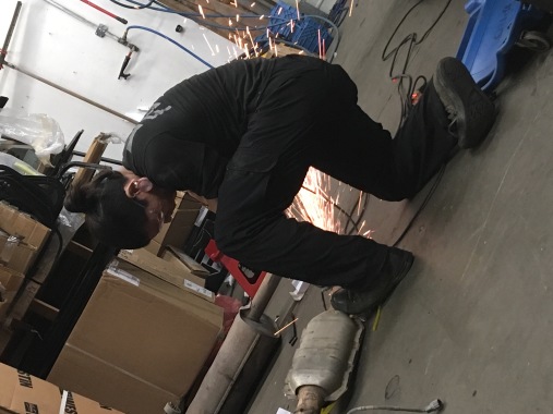 iPhone - Man Grinding an exhaust pipe.