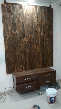 A t.v. unit for a wall mounted t.v. The panel is made from the bark of a tree.