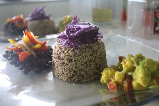 Chef Miingini of Abofa Bistro - stewed black beans topped with grilled sweet red & yellow peppers and onions, red & white quinoa topped with shredded raw red cabbage, accompanied by a side of homemade guacamo 