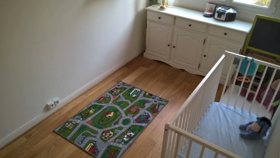 Sol dégagé, avec ses motifs peut servir d'air de jeu pour jouer aux petites voitures! Les vêtements sont rangés dans ce placard transformé en partie en penderie à hauteur d'enfant de trois ans.