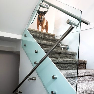Custom Frameless railing glass using 2" diameter standoffs. Plus a handsome boy in the background! www.framelessshower.ca